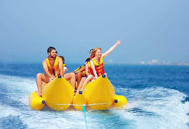 istock happy people having fun on banana boat 487857629