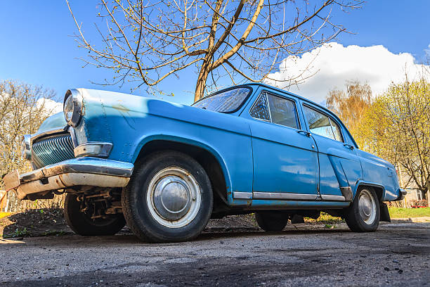 istock Spring fever of  navy blue classic car in back yard 487859029