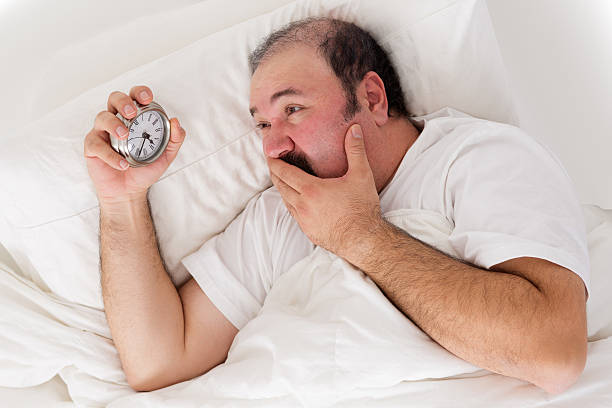 istock Man suffering from insomnia trying to sleep 487859877