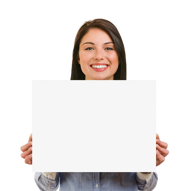 istock Isolated smiling young woman showing blank signboard 487878201