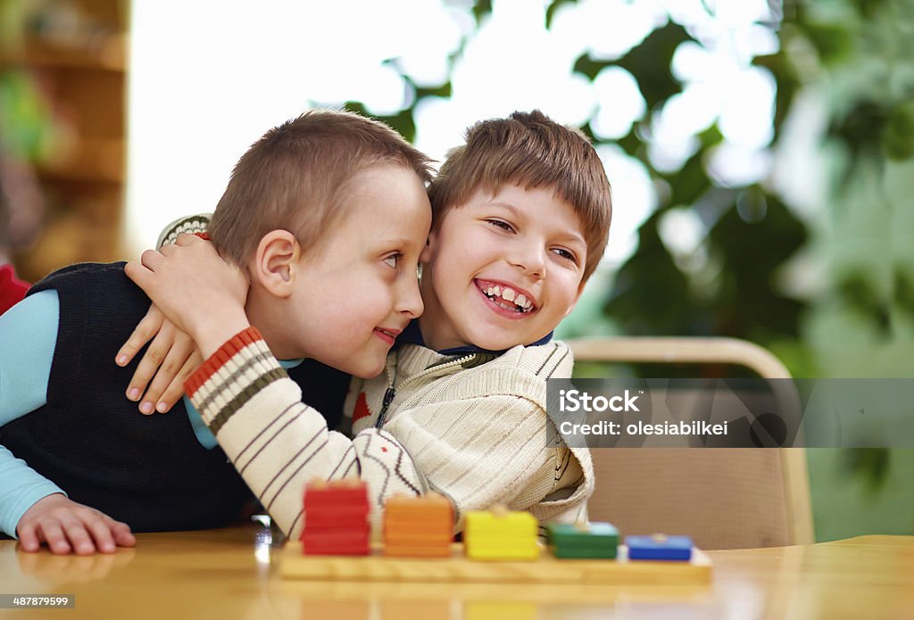 Disabled boys hugging happily in preschool happy kids with disabilities in preschool Disability Stock Photo