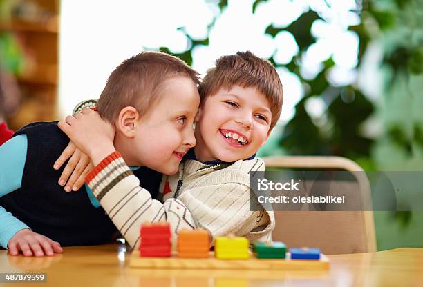 Disabled Boys Hugging Happily In Preschool Stock Photo - Download Image Now - Disability, Child, Physical Disability