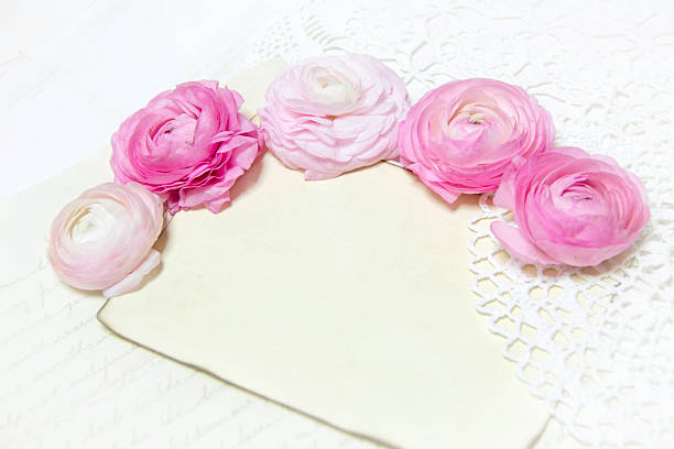 istock Ranunculus flowers, paper and heart background 487880283