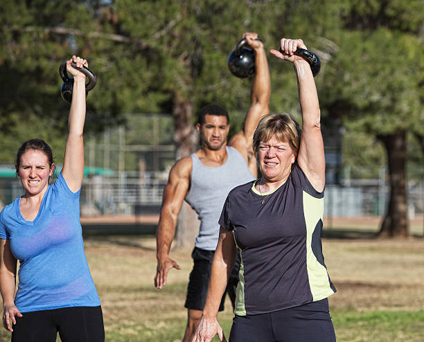 istock Middle Aged Woman Lifting Weights 487881163