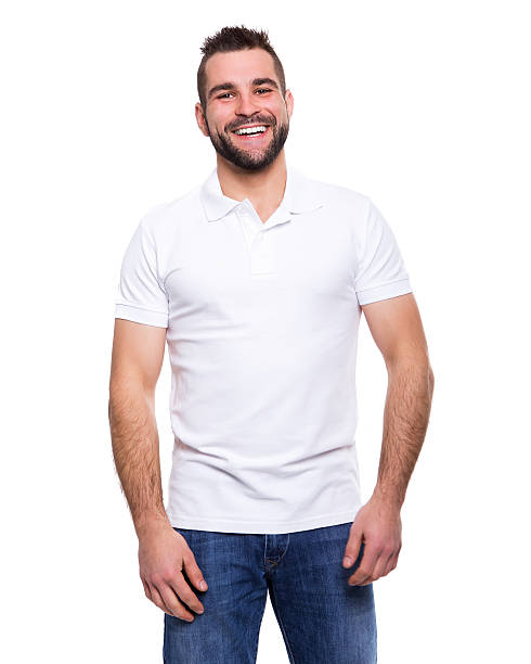 Young happy man in a white polo shirt Young happy man in a white polo shirt on white background polo shirt stock pictures, royalty-free photos & images