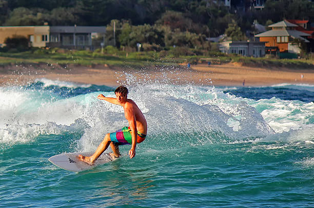 Surfing at Avoca Beach,Australia Avoca Beach,Australia - January 17,2012: An adult male surfer rides a wave on January 17,2012 in Avoca Beach, Australia. avoca beach photos stock pictures, royalty-free photos & images