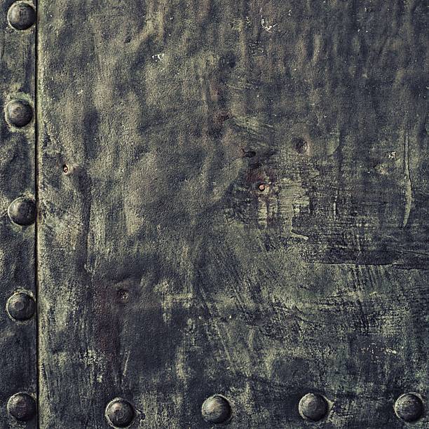istock Grunge black metal plate with rivets screws background texture 487898069