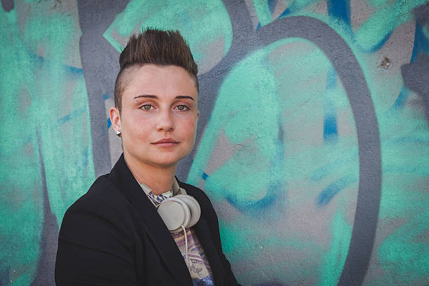 istock Pretty short hair girl posing against a wall 487902189