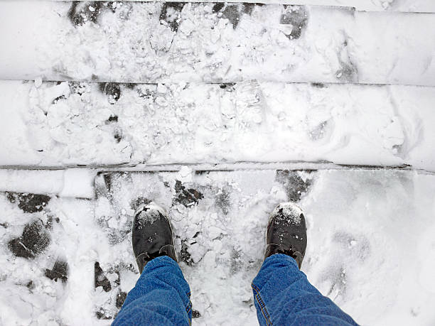 istock Feet on the stairs in a snow. 487913750