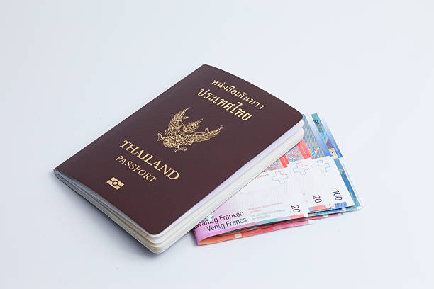 istock Thai passport with switzerland currency. 487914252