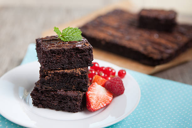Healthy gluten free brownies made with sweet potato and coconut flour. Paleo style brownies on a wooden table, selective focus