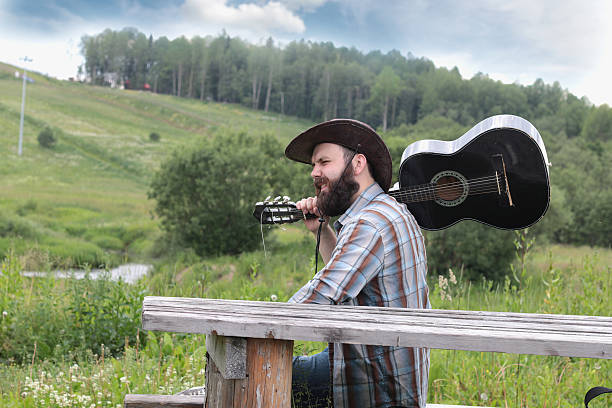 istock guitarist in a cowboy hat on the nature 487916728