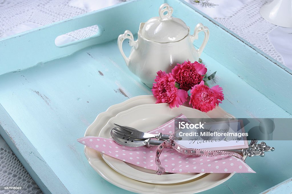 Happy Mothers Day  vintage retro shaby chic tray setting Happy Mothers Day aqua blue breakfast morning tea vintage retro shaby chic tray setting with antique fine china plates, pink carnations and sugar bowl. Mother's Day Stock Photo