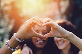 Girls making heart with hands