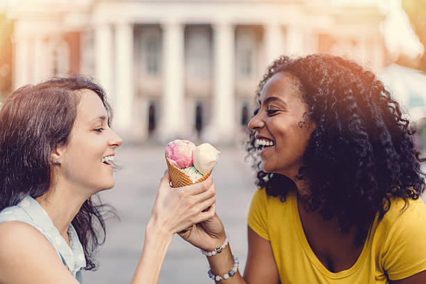 istock Happy girls sharing an ice cream cone 487918384