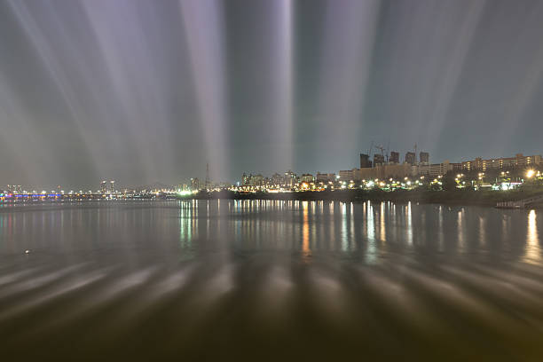 Banpo Bridge Rainbow Fountain show taken inside the fountain looking over the gangnam area along han river taken at night. Seoul famous landmark, with the view of seoul N tower. South Korea.