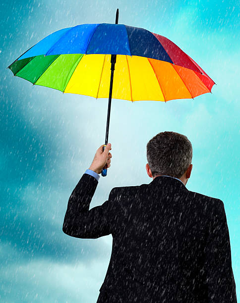 istock business man with rainbow umbrella 487918969