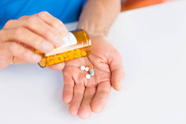 istock Senior Man Taking Prescription Medicines. 487918995
