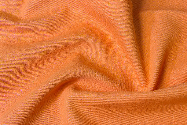 istock Texture of bright, acid orange cloth with pleats 487919252