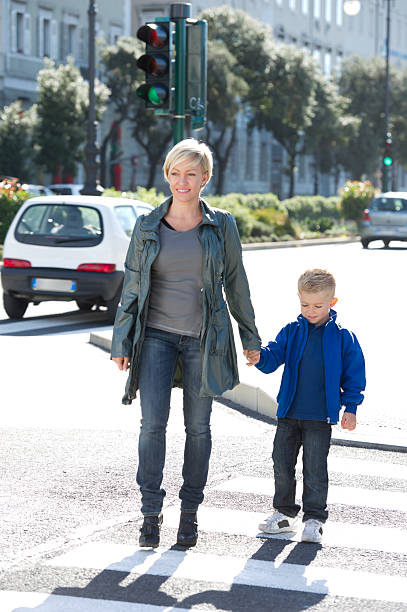 istock Mother And Son Crossing The Cross Walk 487919953