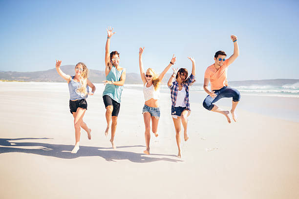 istock Friends running along the beach 487921167