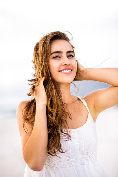 istock Girl with hands in hair smiling 487921267