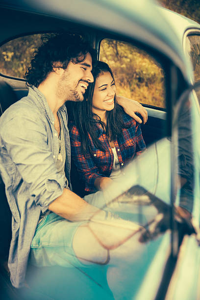 istock Smiling Hipster couple in vintage car 487921295
