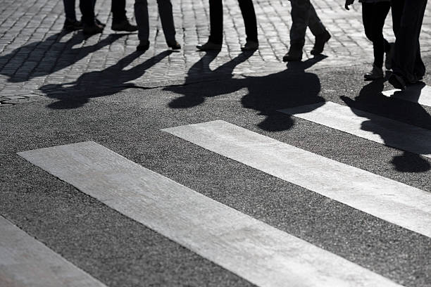 istock Pedestrian crossing with backlit feet in Rome, Italy 487921381