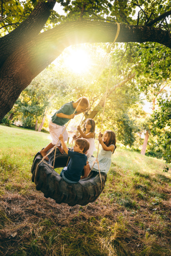 Group of kids sitting in tire swing