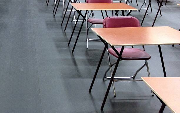 istock Exam hall examination room- desks and chairs 487923146