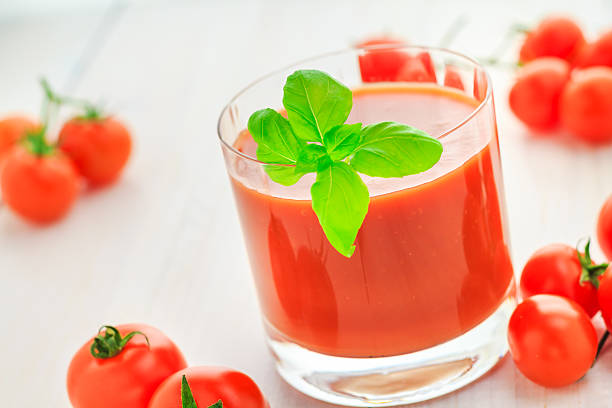 istock Fresh tomato juice wooden background 487923271