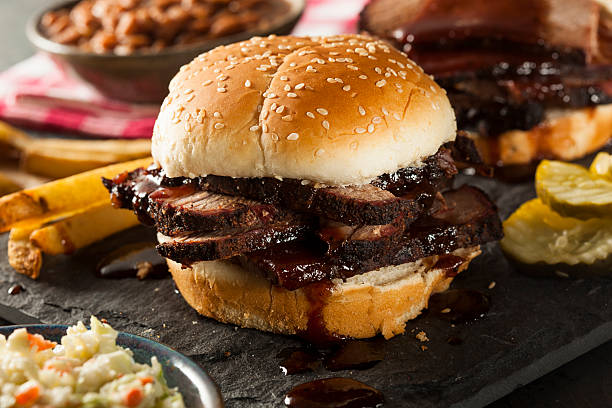 Smoked Barbecue Brisket Sandwich with Coleslaw Smoked Barbecue Brisket Sandwich with Coleslaw and Baked Beans brisket photos stock pictures, royalty-free photos & images