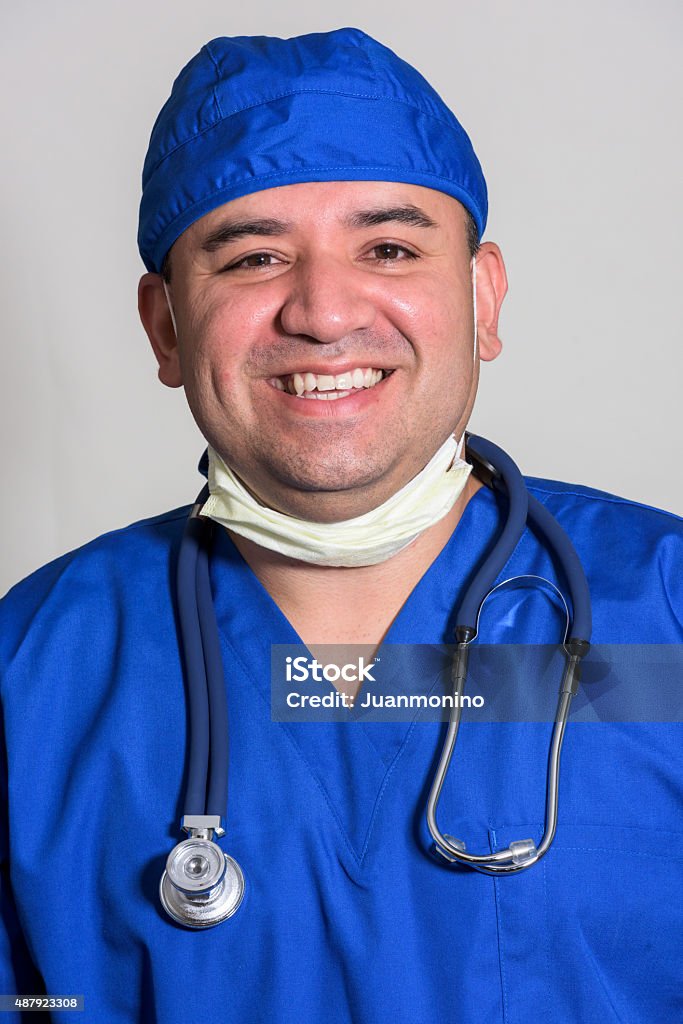 Healthcare worker (real people) Smiling hispanic young male health worker posing on gray background Photo Booth Picture Stock Photo