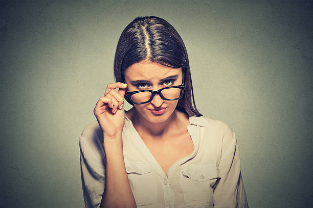 istock angry woman with glasses skeptically looking at you 487924050
