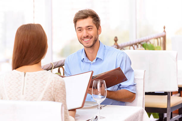 istock Loving couple looking through menu in the restaurant 487924900