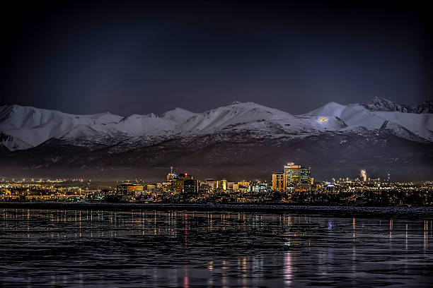 Anchorage at night The Anchorage, Alaska, skyline in winter at night. The Chugach Mountains are in the background and Cook Inlet is in the foreground. anchorage alaska photos stock pictures, royalty-free photos & images
