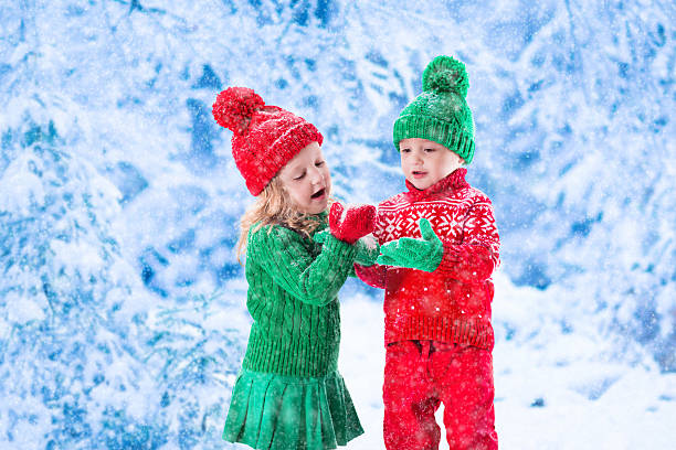 istock Kids playing in snowy winter forest 487925584