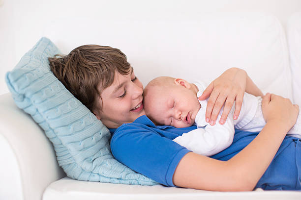 istock Boy holding his newborn baby brother 487925916