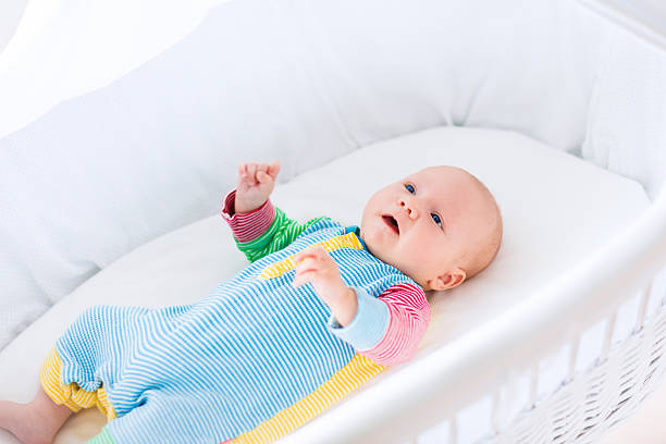 istock Cute baby boy in a white crib 487925966