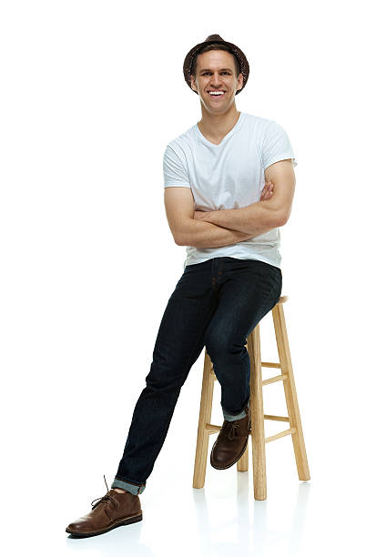 istock Cheerful hipster on stool with arms crossed 487937248
