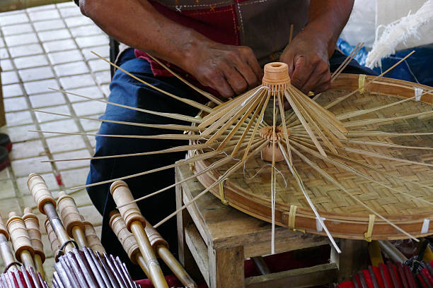 istock artisan is making rattan umbrella handcraft 487944042