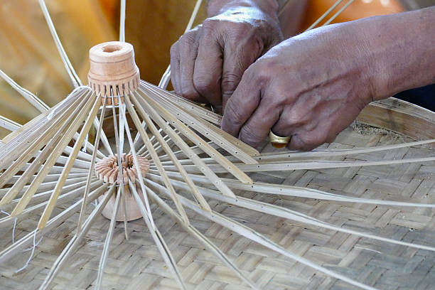 istock artisan is making rattan umbrella handcraft 487945162