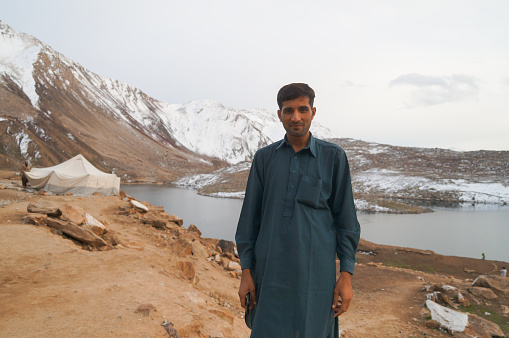 Babusar Pass,Pakistan - October 18,2014: Unknown Pakistani man and a tent for local people at the lake near Babusar Pass,Pakistan.
