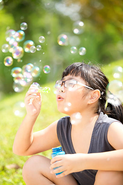 istock Young Asian girl playing sand in park 487949592
