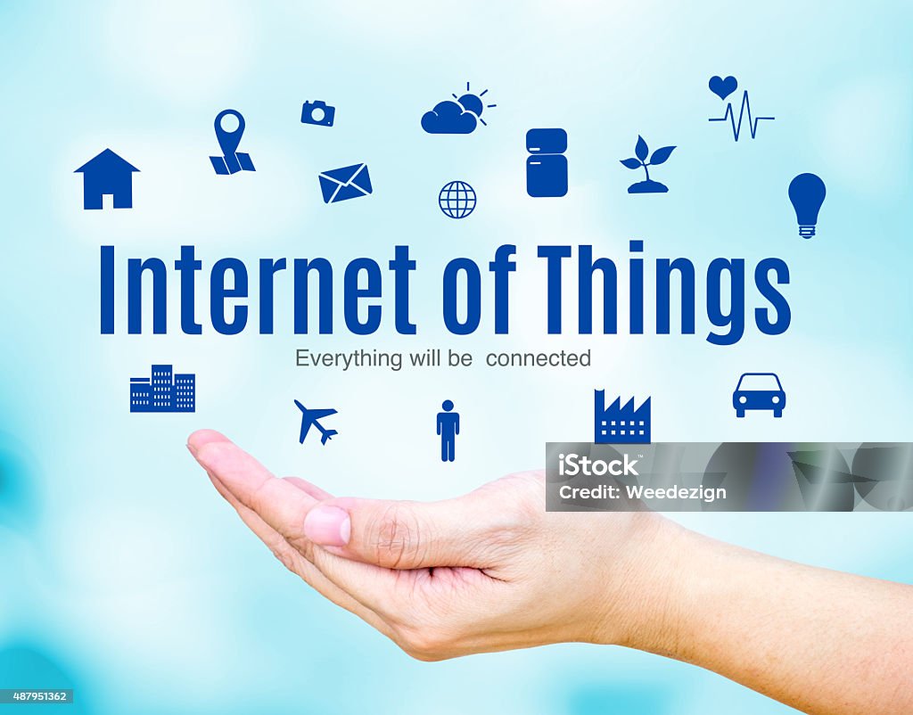 Open hand with Internet of Things (IoT) word and icon Open hand with Internet of Things (IoT) word and icon on blue blur background, Technology concept. 2015 Stock Photo