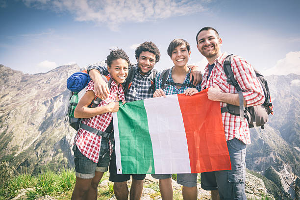 istock People with Italian Flag on top of Mountain 487960367