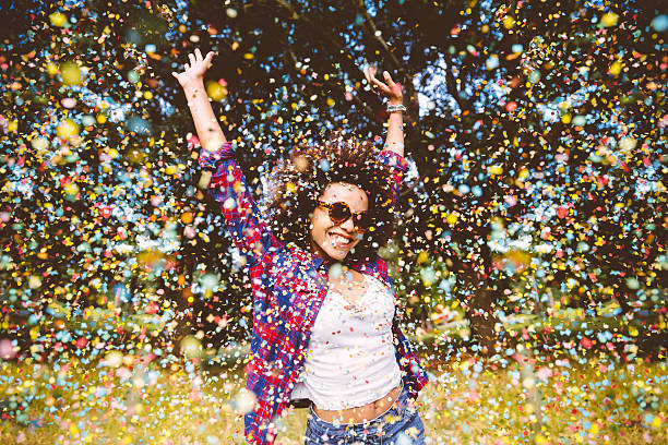 Hipster enjoying confetti Hipster enjoying confetti arms outstretched photos stock pictures, royalty-free photos & images