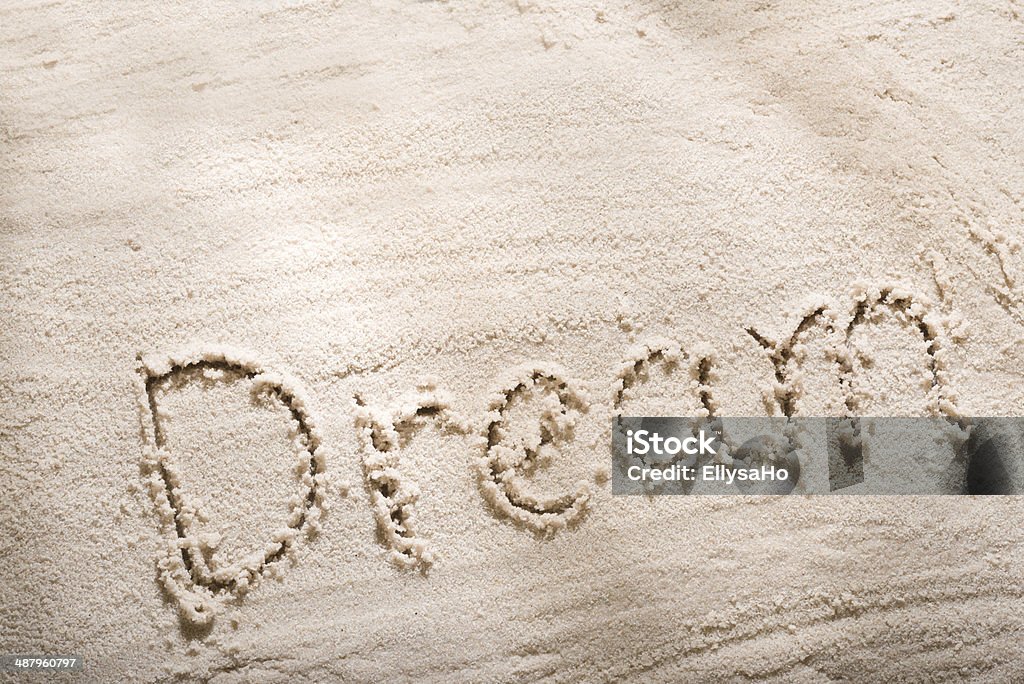 Dream word in sand Dream word in sand, beach writing with sun light Beach Stock Photo