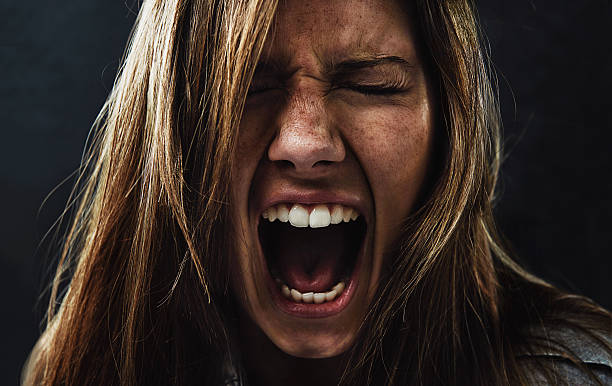 She's reached the end of her rope! A young woman screaming uncontrollably while isolated on a black background terrified stock pictures, royalty-free photos & images