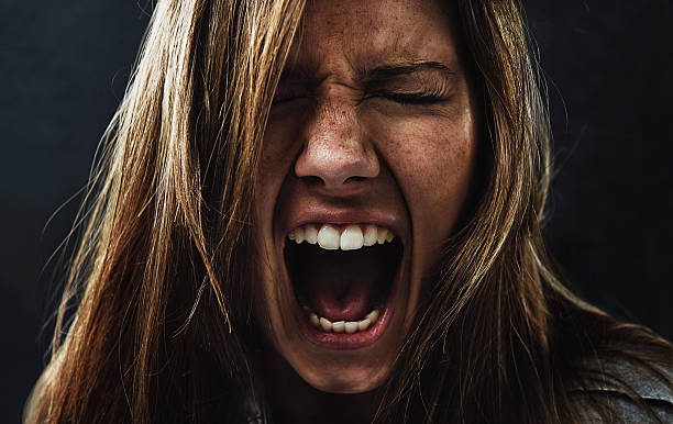 She's reached the end of her rope! A young woman screaming uncontrollably while isolated on a black background touch sensitive stock pictures, royalty-free photos & images